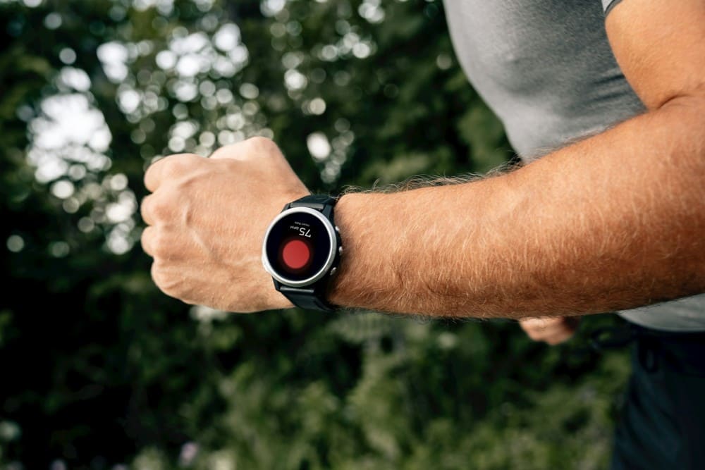 Sportif homme qui fait de la course avec sa montre connectée GPS